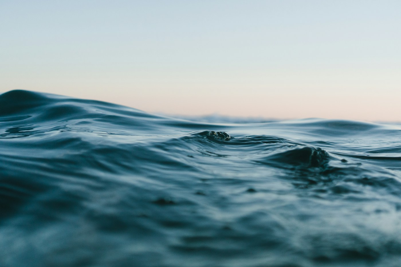Small ocean waves beneath a soft evening sky