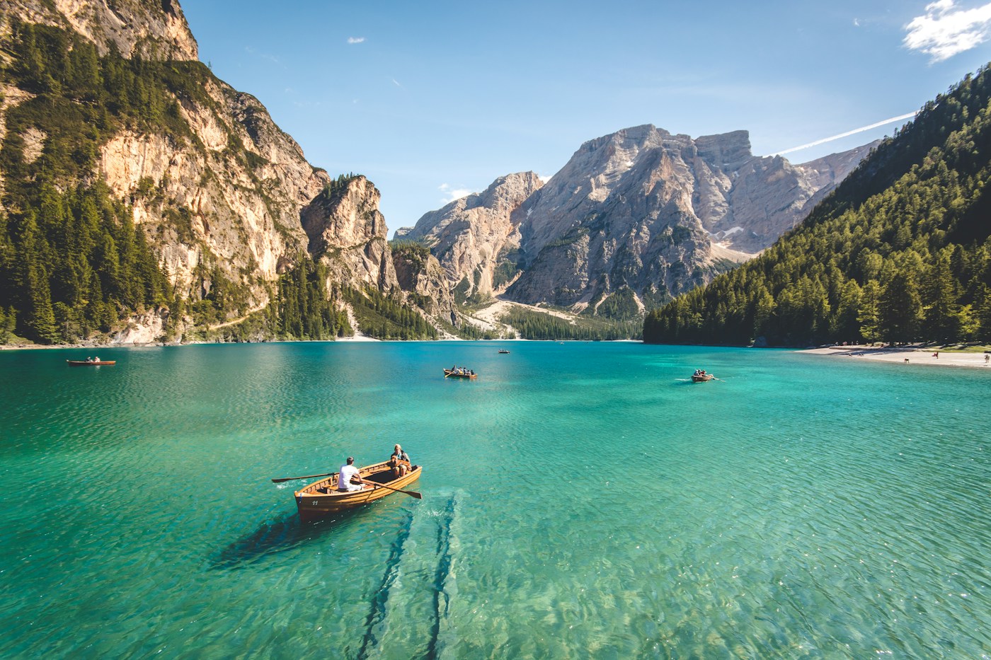 A still lake surrounded by dramatic mountain peaks